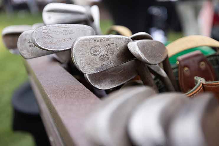 Assortment of golf clubs with hickory handles to be used in the tournament.